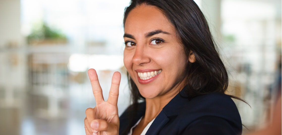 Cheerful_woman_showing_victory_sign