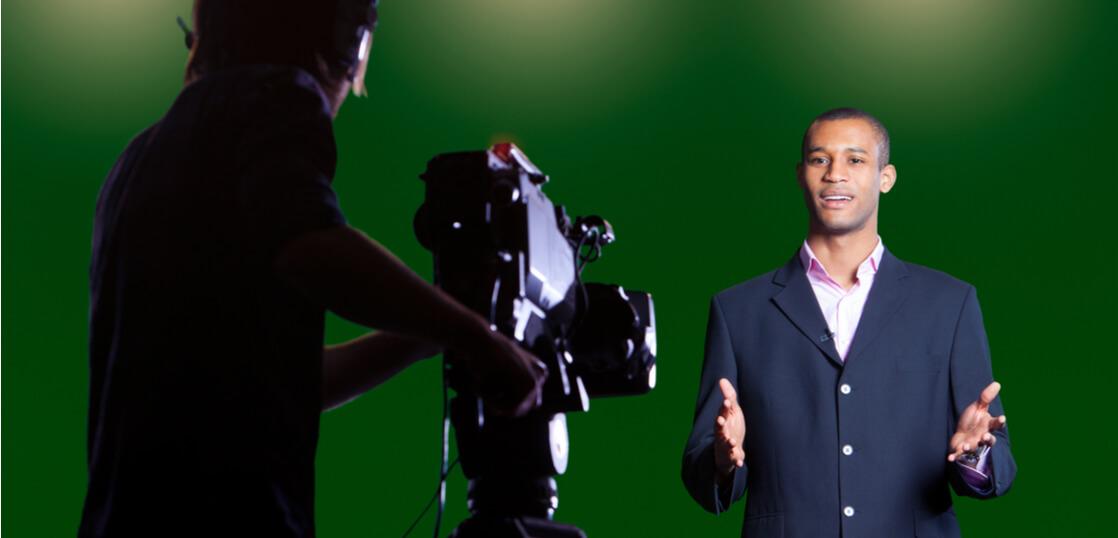 Presenter-talking-to-camera-in-a-green screen-studio